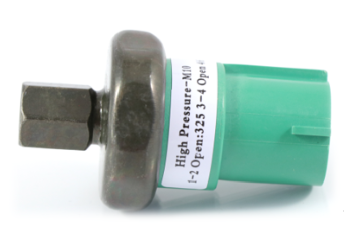 Advance Truck Parts USA 06-35209-000 Ford Sterling binary switch showing a studio side perspective of the metallic body and green electrical connector