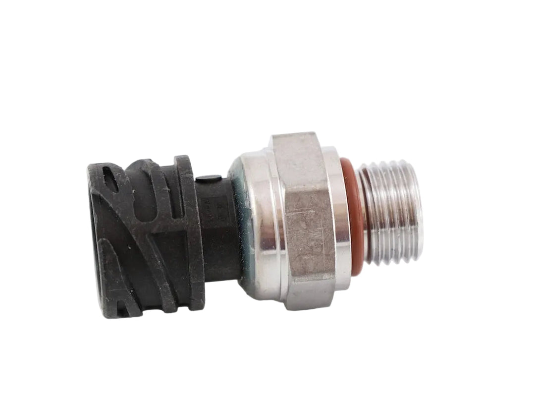 Advance Truck Parts USA 20898038 Volvo pressure sensor showing a close-up studio perspective of the threaded metal fitting, red O-ring seal, and black connector housing