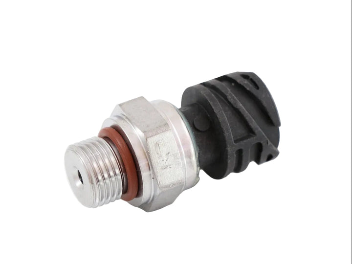 Advance Truck Parts USA 21634021 Mack Volvo fuel pressure sensor featuring threaded metal inlet, orange sealing O-ring, hex collar, and black electrical connector housing