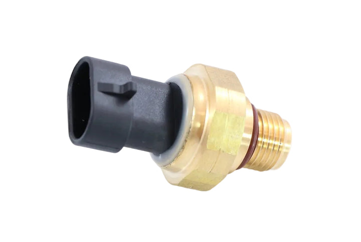 Advance Truck Parts USA 3072491 Cummins oil pressure sensor showing a close-up studio perspective of the brass threaded base with O-ring and black connector