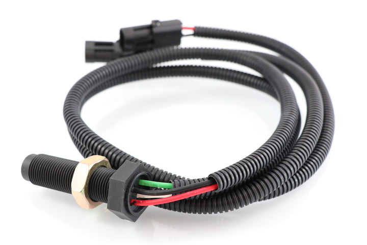 Advance Truck Parts USA 4327231 Cummins speed sensor showing a clean studio view of the threaded probe, exposed wire leads, protective loom, and dual connectors on a plain white background