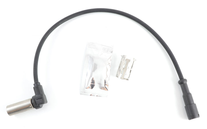Advance Truck Parts USA 4410329212 ABS sensor kit showing a close-up studio perspective of the sensor probe, wiring harness, dielectric grease packet, and installation clip