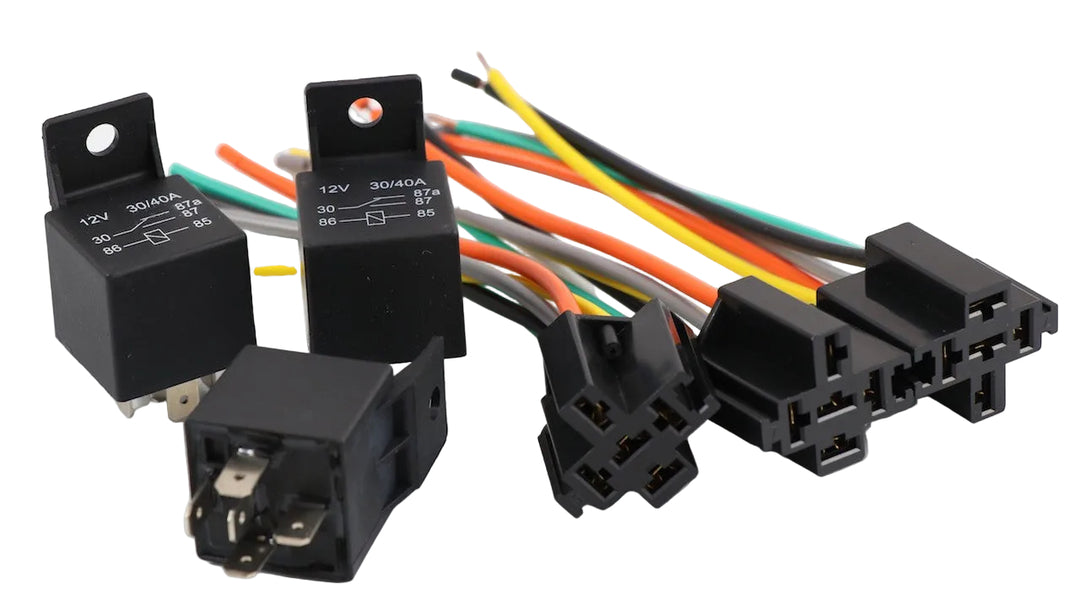 Advance Truck Parts USA 5-pack 12V 40A 5-pin relays and harness sockets showing a clean studio view of multiple black relay units and wiring harnesses on a plain white background
