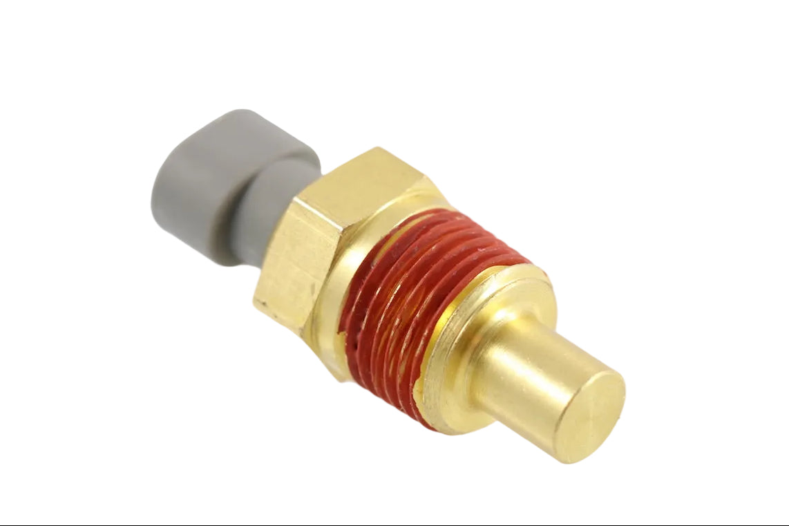 Advance Truck Parts 1675751C1 temperature sender gauge for International Navistar buses and trucks showing an angled studio view of the brass threaded body with red sealant and grey electrical connector on a plain white background