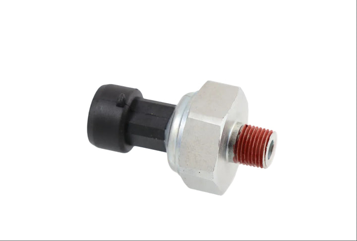 Advance Truck Parts USA 20706315 oil pressure sensor for Mack and Volvo trucks featuring a hex fitting, threaded port with red sealant, and a black connector on a plain background