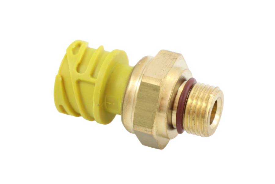 Advance Truck Parts USA 21634017 crankcase pressure sensor for Volvo trucks showing an angled profile of the brass threaded port, orange O-ring seal, hex tightening body, and original yellow connector housing on a plain white background