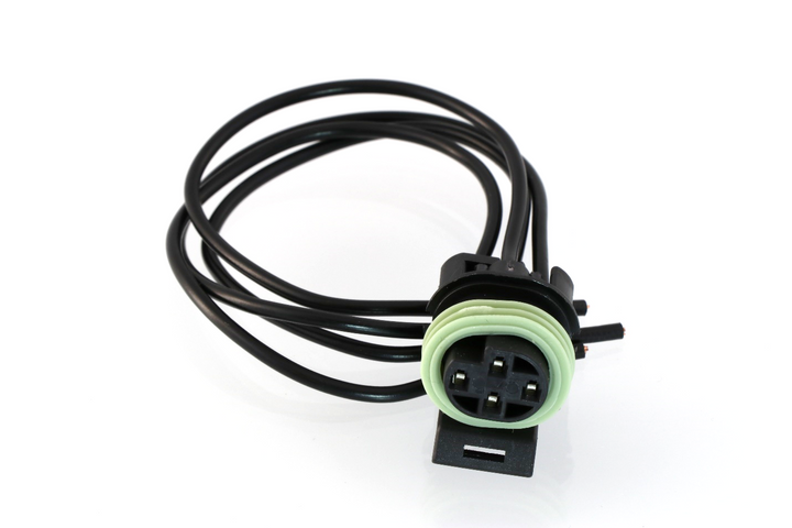 Advance Truck Parts USA 3824257 pigtail connector for coolant level sensors featuring black wire leads, mounting tab, and a light green seal 