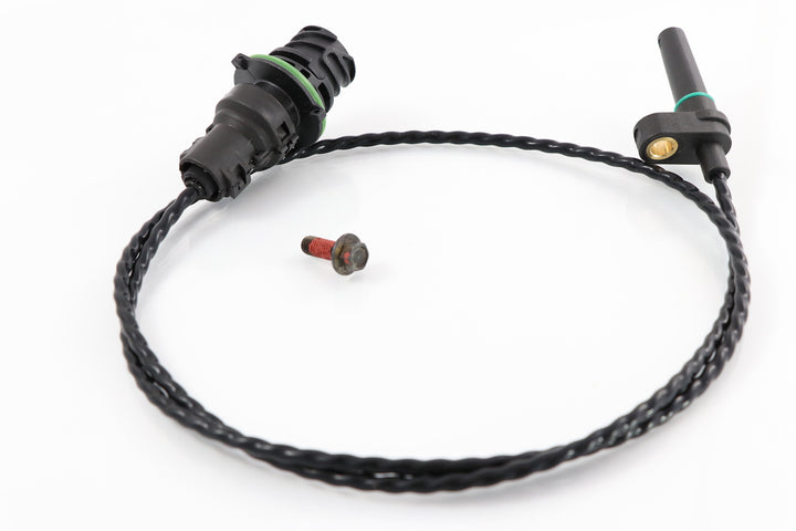 Advance Truck Parts USA 85151481 turbocharger speed sensor for Mack and Volvo showing a top-down view of the black twisted wire cable, 2-pin electrical connector with a green O-ring, sensor probe, and included mounting screw on a plain white background