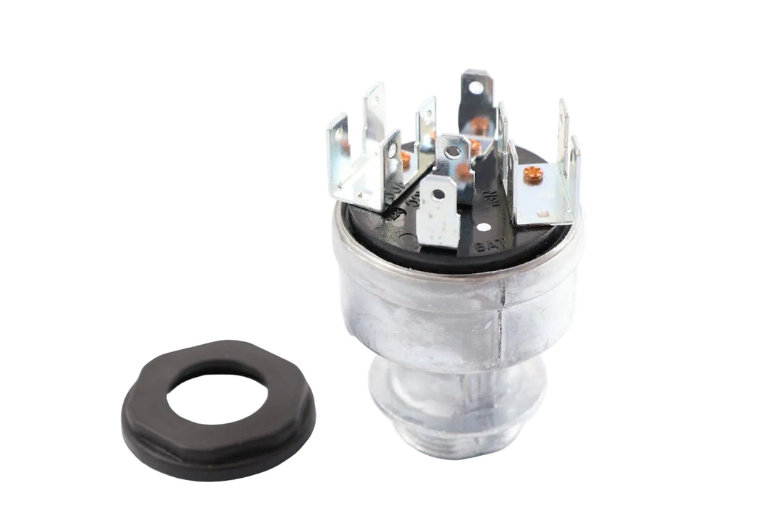 Advance Truck Parts USA A06-22717-001 ignition switch for Freightliner trucks featuring 11 terminal blades and a mounting retention nut on a plain background