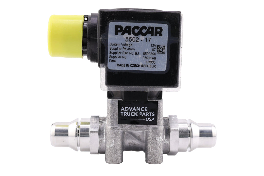 Advance Truck Parts USA Genuine Paccar 5502-17 DEF heater control coolant valve showing a horizontal profile of the black solenoid coil with printed OEM specifications, metallic fluid body, and yellow connector cap on a plain white background
