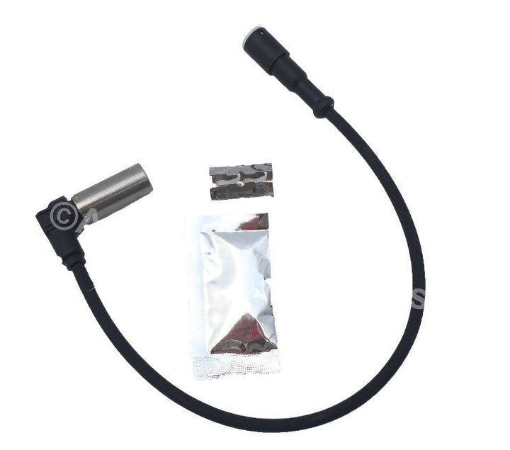 Advance Truck Parts USA ABS sensor kit showing a studio layout of the sensor assembly, dielectric grease packet, and metal clip