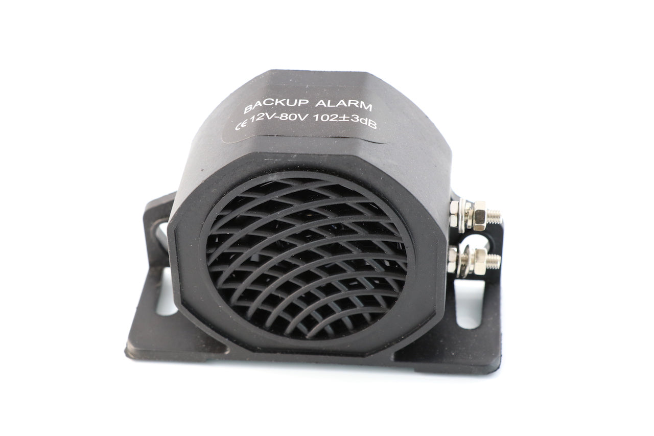 Advance Truck Parts USA commercial heavy-duty back up alarm showing a clean studio view of the black speaker housing, grill pattern, and mounting bracket on a plain white background