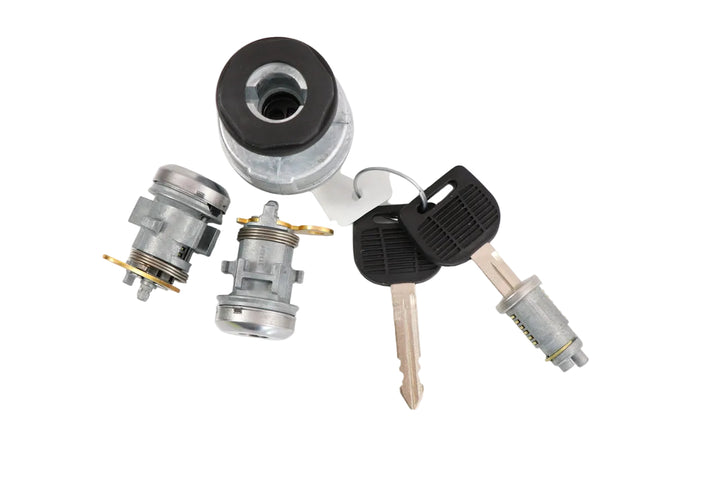 Freightliner Cascadia and M2 original ignition switch set with lock cylinders and keys on a plain background