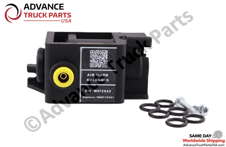 Advance Truck Parts USA branded studio front perspective showcasing the complete air horn solenoid replacement kit featuring the black housing with a printed QR code identification label, a yellow-ringed air port, eight O-rings, and mounting hardware for Navistar International commercial trucks