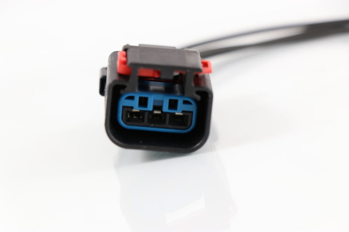 Advance Truck Parts USA W094100 3-wire pigtail harness connector showing a clean studio view of the black plug housing, blue seal, and red locking tab on a plain white background