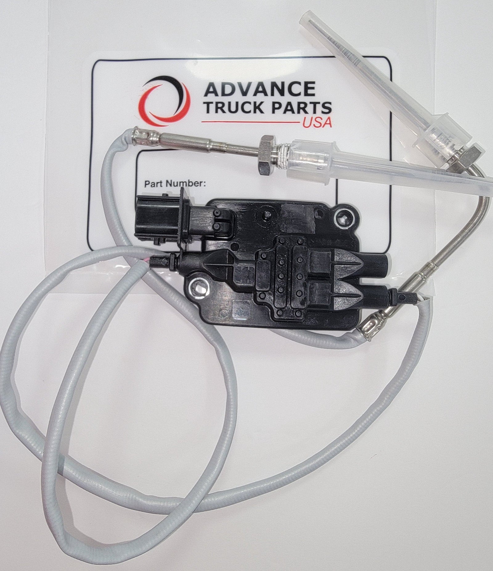 Advance Truck Parts USA 5461643 replacement temperature sensor for Cummins engines showing a top-down perspective of the black electronic module, long grey wiring harness, and metal sensing probes with clear plastic protective caps resting on branded factory packaging