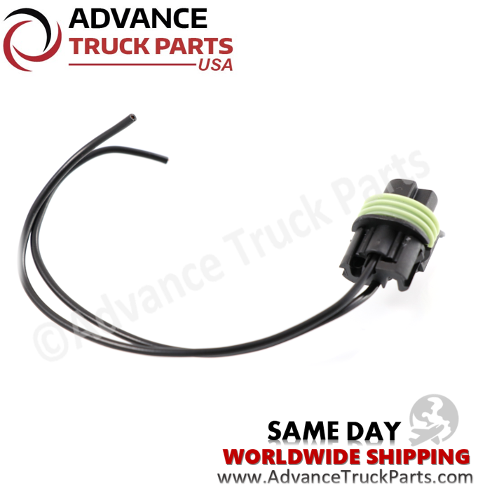 Advance Truck Parts USA studio angled perspective from the rear highlighting the wire entry points, black connector housing, green ribbed seal, and black wire leads of the heavy-duty pressure switch pigtail connector