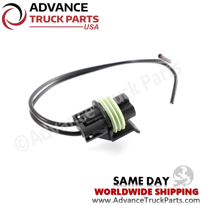 Advance Truck Parts USA studio angled perspective showcasing the black connector housing, green ribbed seal, locking tab, and black wire leads of the pressure switch pigtail connector