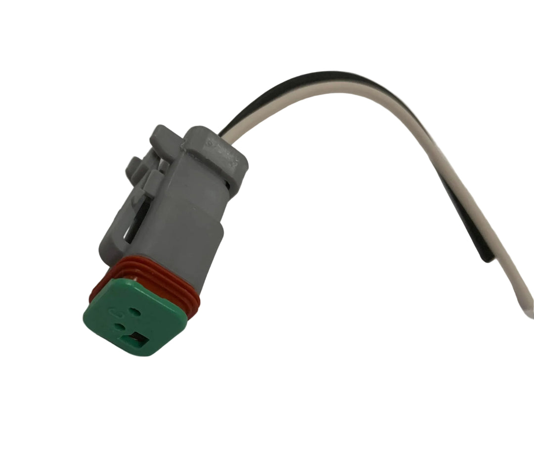 Advance Truck Parts USA W094125 Deutsch DT style 2-pin pigtail connector showing a clean studio view of the grey housing, green wedge lock, orange seal, and wire leads on a plain white background